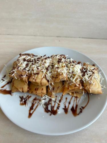 a white plate with a piece of food with chocolate at The volcano in Kubupenlokan