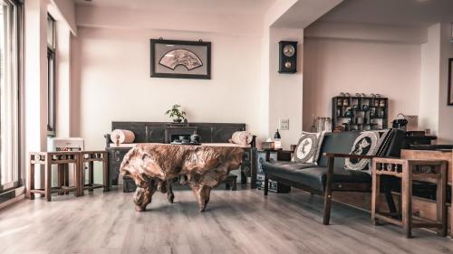 a large cow standing in a room with chairs at 隱山居 海景包棟2-10人 in Jiufen