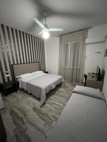 a bedroom with a white bed and a window at e gal in Cervia