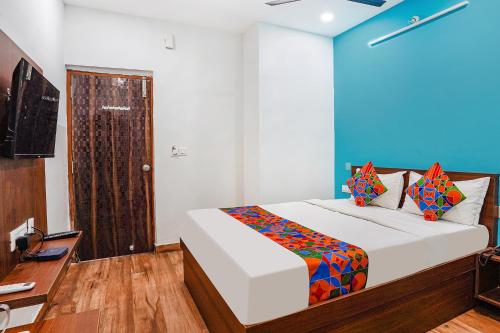 a bedroom with a bed and a desk and a television at Hotel RLV Green Palace - Nr Kengeri Satellite Town in Bengaluru