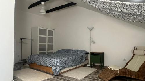 a bedroom with a bed and a chair at Samostatný byt v rodinnom dome in Revúca