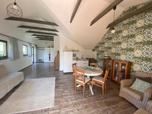 a living room with a table and a kitchen at Samostatný byt v rodinnom dome in Revúca