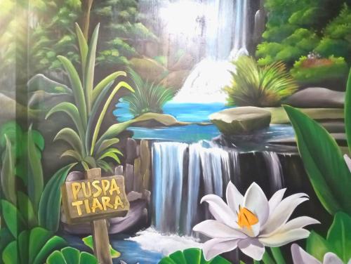 a painting of a waterfall and a white flower at Puspa Tiara Syar'i Guci Mitra RedDoorz in Tuwel