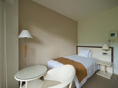 Un pat sau paturi într-o cameră la HOTEL HOLISTIC RESORT - Vacation STAY 34520v