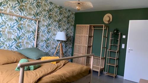 une chambre avec un lit et un mur végétal dans l'établissement Villa Jules Verne, au Crotoy