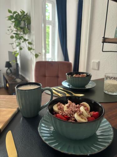 a bowl of food on a table with a cup of coffee at Five O- KingSize Apartment Hesse in Wittenberge