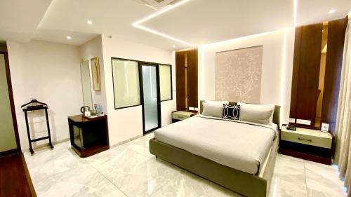 a bedroom with a large bed in a room at The Manohar Hyderabad in Hyderabad