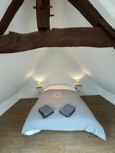 a bedroom with a bed with two pillows on it at Gites du Manoir de Kergoniou Saint Joseph in Paimpol