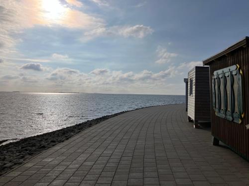 a walkway next to a body of water at Nordpalais vor Sylt in Emmelsbüll-Horsbüll