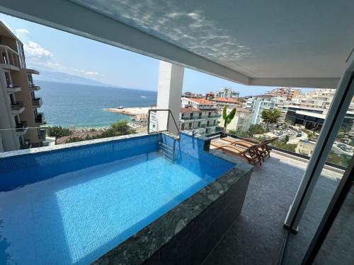 a swimming pool with a view of the ocean at DREAM HOTEL SARANDA in Sarandë