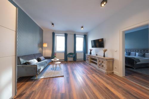 a living room with a couch and a table at Nurban Apartments City 2 in Nürnberg