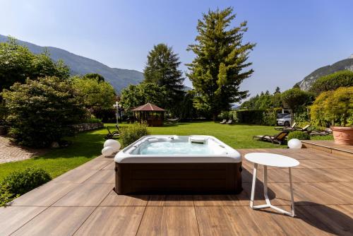 a hot tub sitting on top of a wooden deck at Hotel Lido - slow & natural living in Molveno