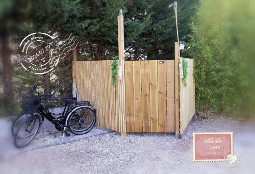 a bike parked next to a wooden fence at Maison de Charme en couleurs in Cuers