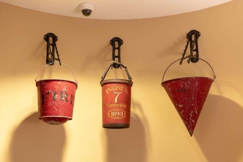 two red lanterns are hanging on a wall at The Kendall Hotel at the Engine 7 Firehouse in Cambridge
