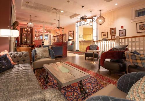 a living room with couches and a coffee table at The Kendall Hotel at the Engine 7 Firehouse in Cambridge