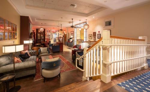 a living room with a couch and a staircase at The Kendall Hotel at the Engine 7 Firehouse in Cambridge