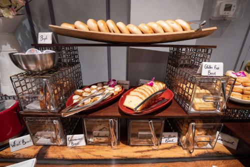 a display of bread and pastries on a table at The Kendall Hotel at the Engine 7 Firehouse in Cambridge