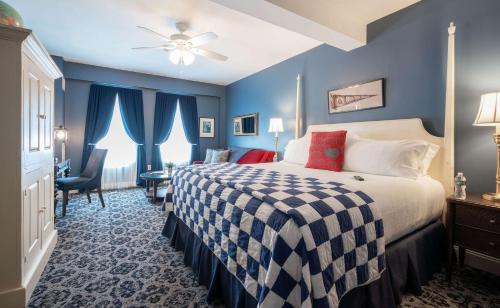 a bedroom with a bed with a checkered blanket at The Kendall Hotel at the Engine 7 Firehouse in Cambridge