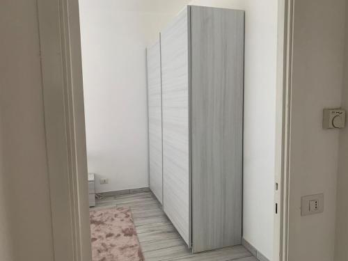 a room with a closet with a door and a rug at Melis Apartment by Quokka 360 - on the lake of Como in Como