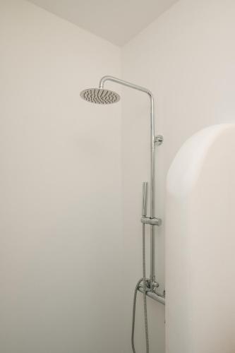 a mirror in a bathroom with a white wall at Amorgos Elegant Houses, 6 Villas in Amorgos