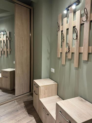 a bathroom with wooden cabinets and mirrors on the wall at New Gudauri Apartment NEO 223 in Gudauri