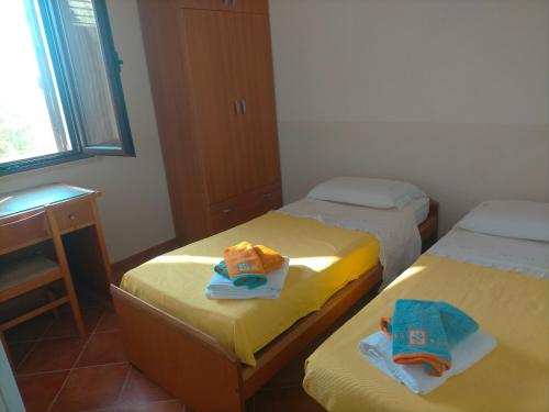 two beds in a room with towels on them at Menzel el Emir in Misilmeri