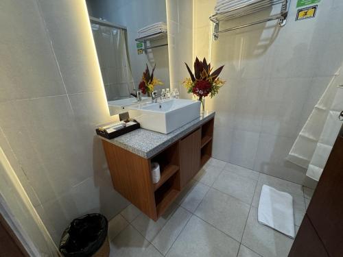 a bathroom with a sink and a mirror at New Garden View Resort - CHSE Certified in Legian