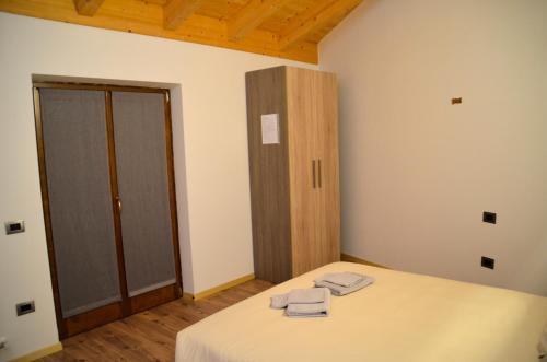 a bedroom with a bed with two towels on it at La Caigola in Ala