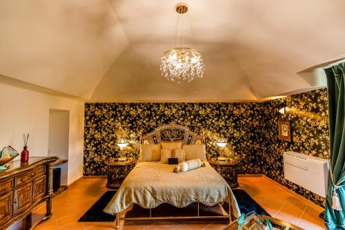 a bedroom with a bed and a chandelier at Castello Brancaccio in San Gregorio da Sassola