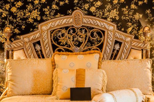 a bed with an ornate headboard in a room at Castello Brancaccio in San Gregorio da Sassola