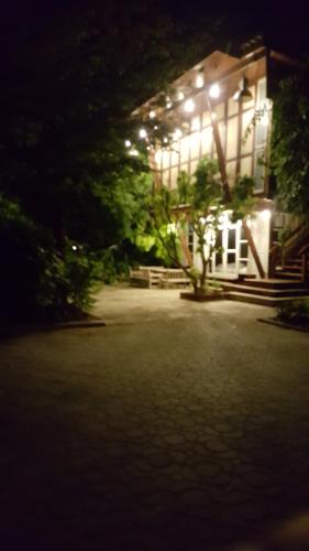 a house lit up at night with lights on it at Ruean Mai Chai Khlong in Amphawa