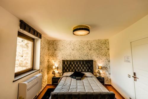 a bedroom with a bed and a window at Castello Brancaccio in San Gregorio da Sassola