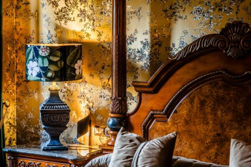 a bedroom with a bed and a lamp on a table at Castello Brancaccio in San Gregorio da Sassola
