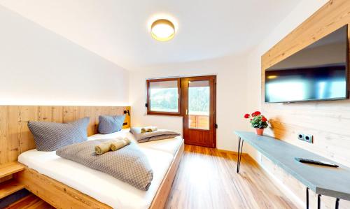 a living room with a couch and a television at Haus Moritz in Oetz