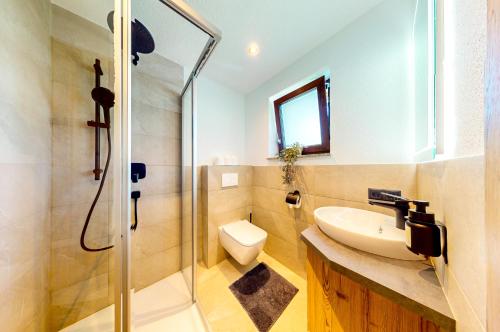a bathroom with a shower and a sink and a toilet at Haus Moritz in Oetz