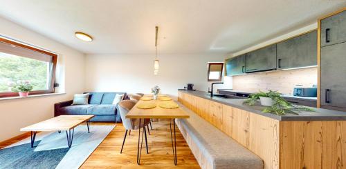 a kitchen and living room with a table and a couch at Haus Moritz in Oetz