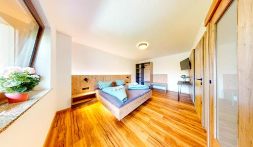 a bedroom with a bed with blue pillows at Haus Moritz in Oetz