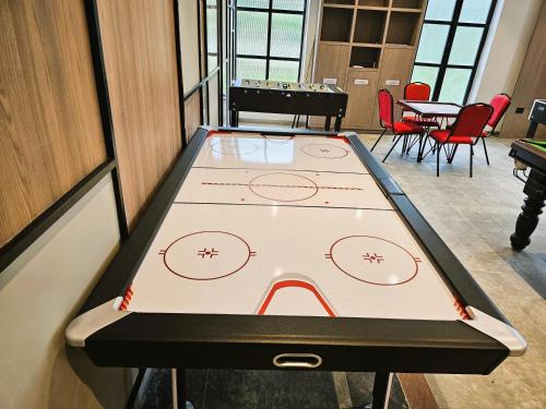a ping pong table in a room with chairs at Bhanu The Fern Forest Resort & Spa, Jambughoda in Jambughoda