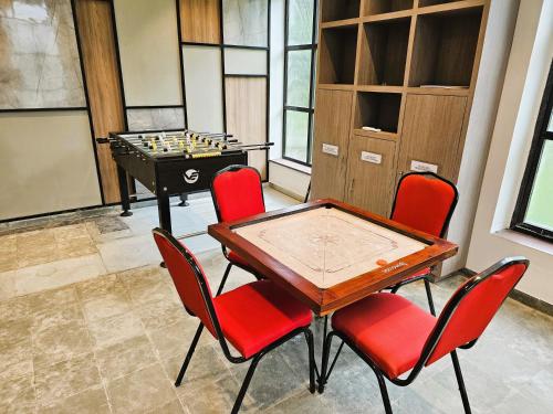 a room with a table and chairs and a chess board at Bhanu The Fern Forest Resort & Spa, Jambughoda in Jambughoda