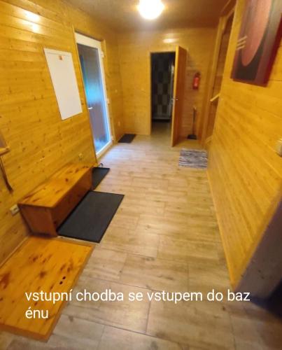 a hallway with a wooden floor and a wooden bench at Apartmánová chata Sečanda s bazénem, u Sečské přehrady in Seč