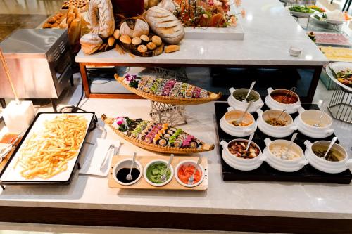 a buffet with many different types of food on display at Brilliant Hotel - Afternoon Tea Inclusive in Da Nang