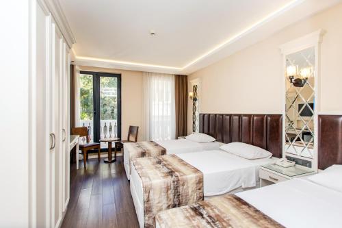 a hotel room with two beds and a table at Morava Hotel in Istanbul