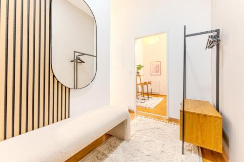 a dressing room with a mirror and a bench at Hakuna Cozy-Living city Center - free parking in Graz