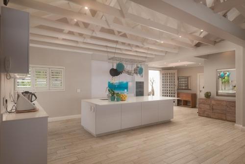 a kitchen with a white island in a room at The Sugar Shack in Ballito