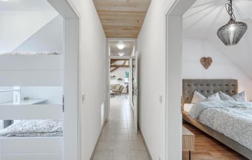 a bedroom with white walls and a bed and a hallway at Kleiner Fuchs in Irrhausen