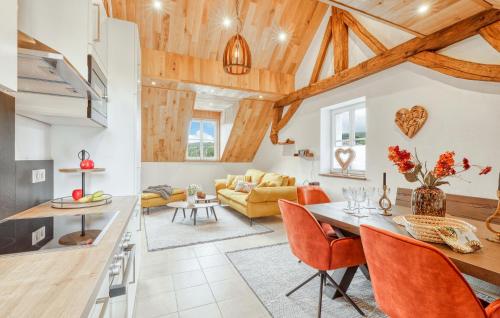 a kitchen and living room with wooden ceilings at Kleiner Fuchs in Irrhausen
