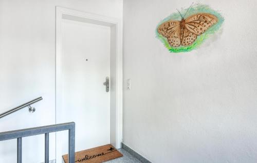 a butterfly on the wall next to a door at Kaisermantel in Irrhausen