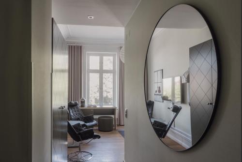a mirror on a wall next to a living room at TwentySix in Malmö
