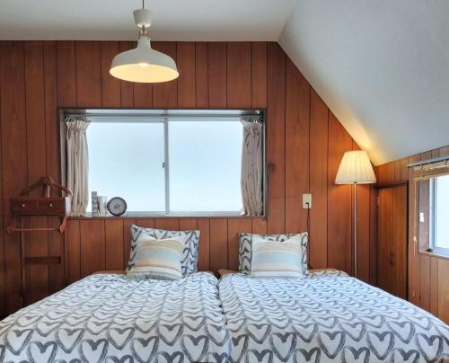 a bedroom with a large bed with a window at JOY HOUSE Near Ikebukuro in Tokyo
