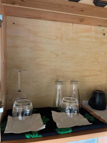three glass jars sitting on a black tray with napkins at Eagle View Lodge - Kigali in Kigali